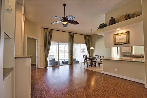 a view of a livingroom with furniture window wooden floor and chandelier
