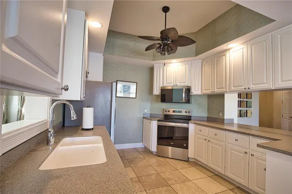 a kitchen with stainless steel appliances granite countertop a stove sink and refrigerator