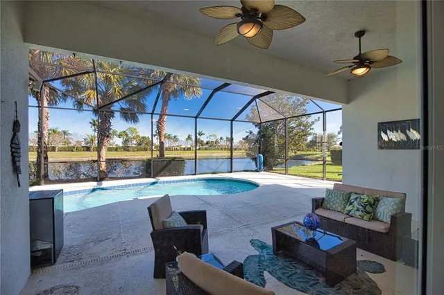 a dining room with furniture and a floor to ceiling window