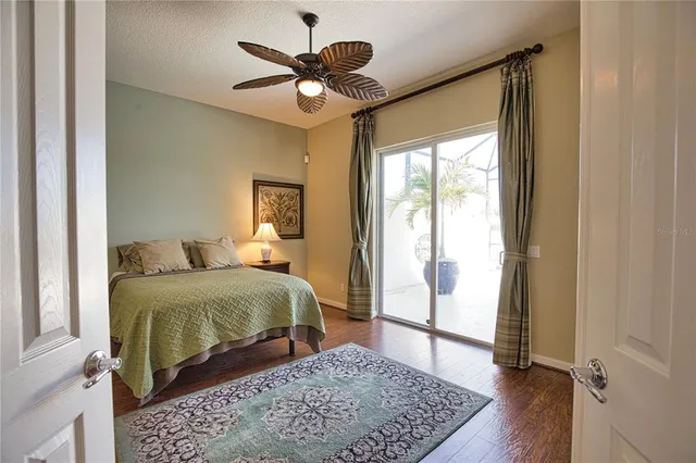 a bedroom with a large bed and a chandelier