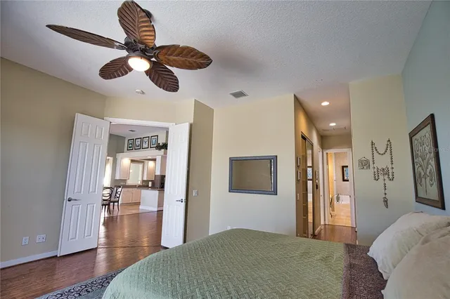 a bedroom with a bed and a chandelier