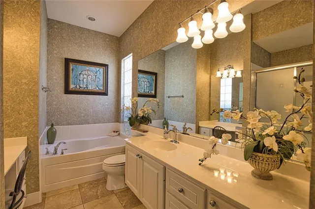 a bathroom with a tub sink and mirror