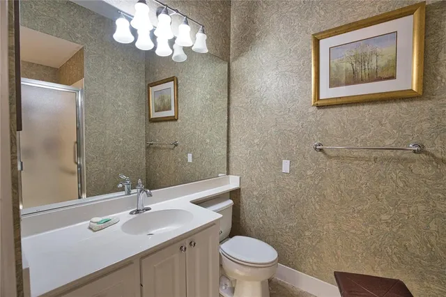 a bathroom with a toilet a sink and mirror