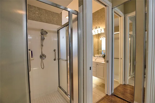 a bathroom with a glass shower door