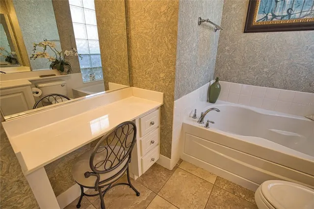 a bathroom with a bathtub sink and a window