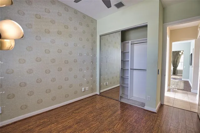 a view of empty room with wooden floor
