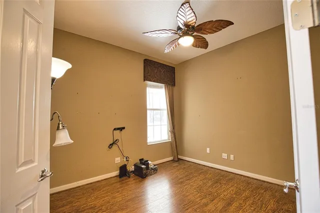 a view of a room with a window and wooden floor
