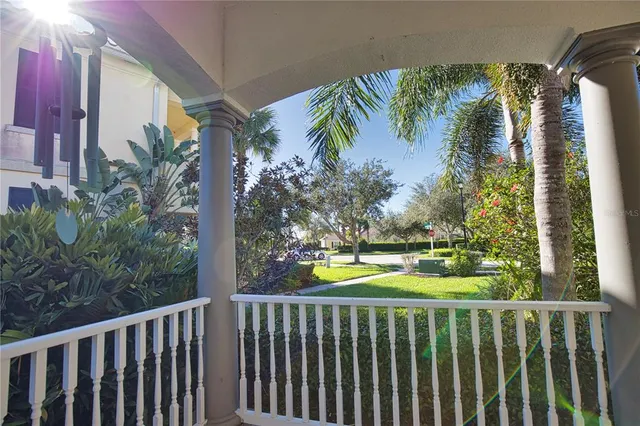 a view of a balcony with plants and wooden fence