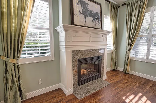 a living room with a fireplace and a window