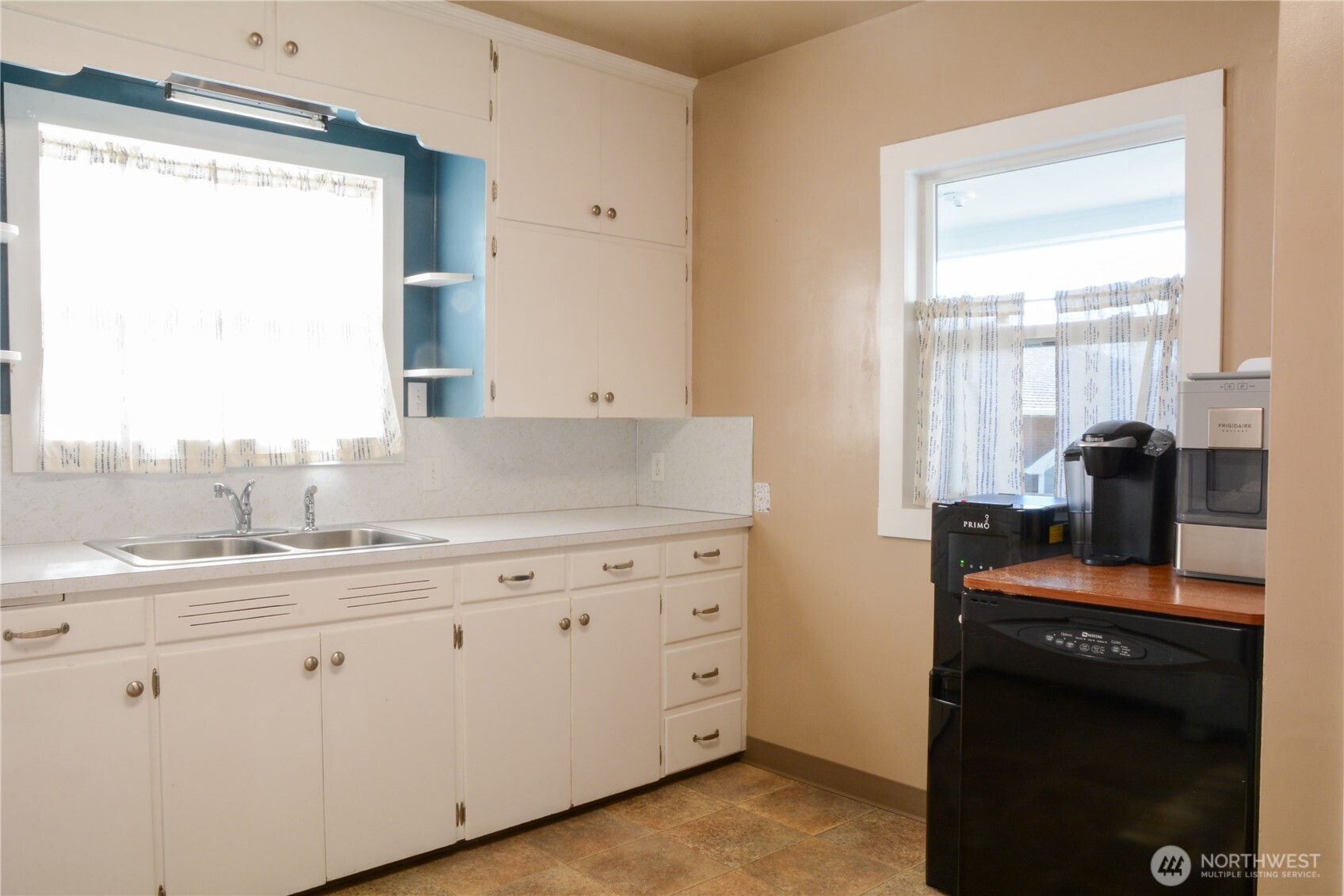 112 East 5th Street Lind, WA 99341 - Photo 7 of 39 a kitchen with appliances cabinets and a large window