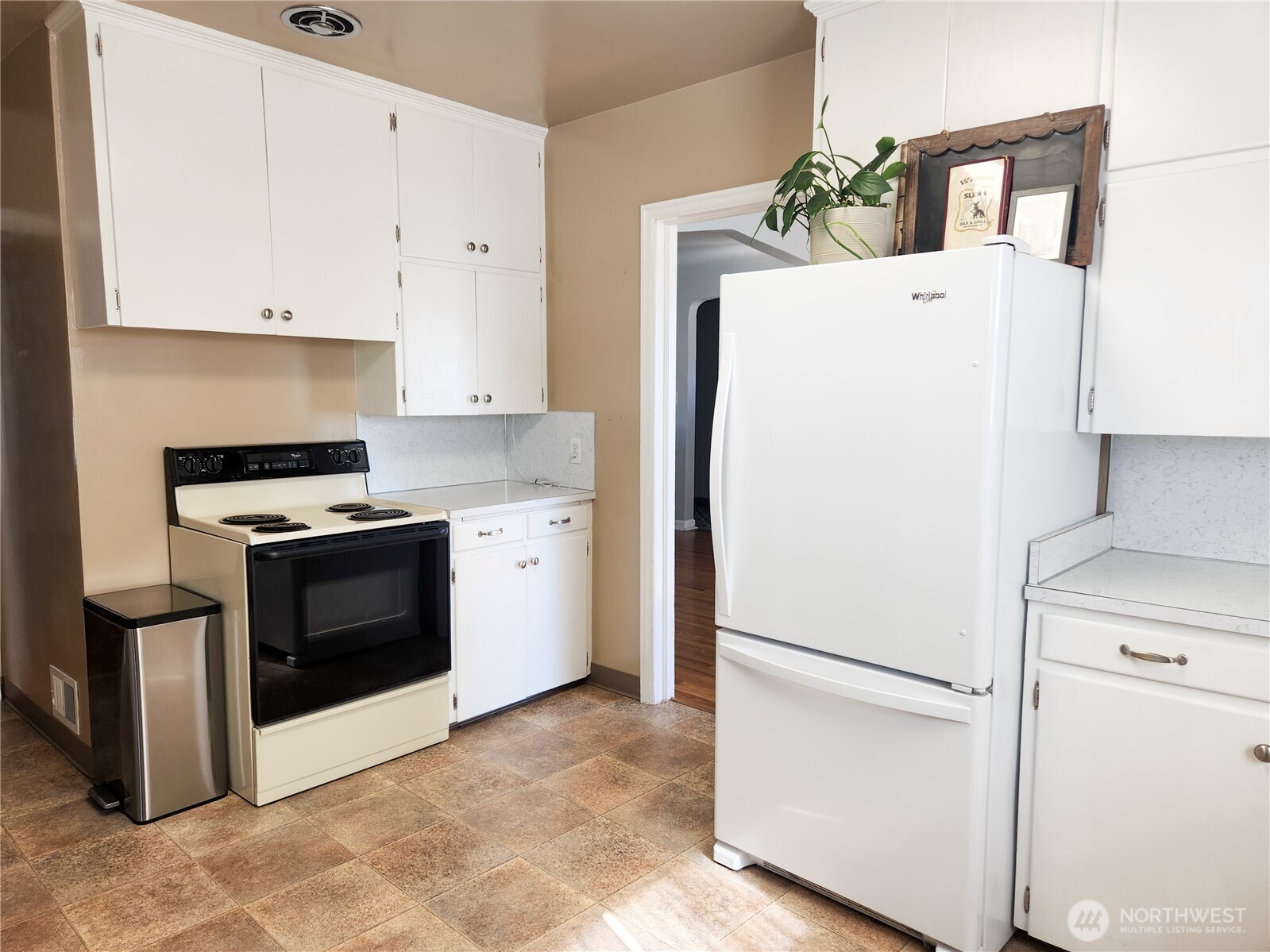 112 East 5th Street Lind, WA 99341 - Photo 8 of 39 a white refrigerator freezer sitting in a kitchen