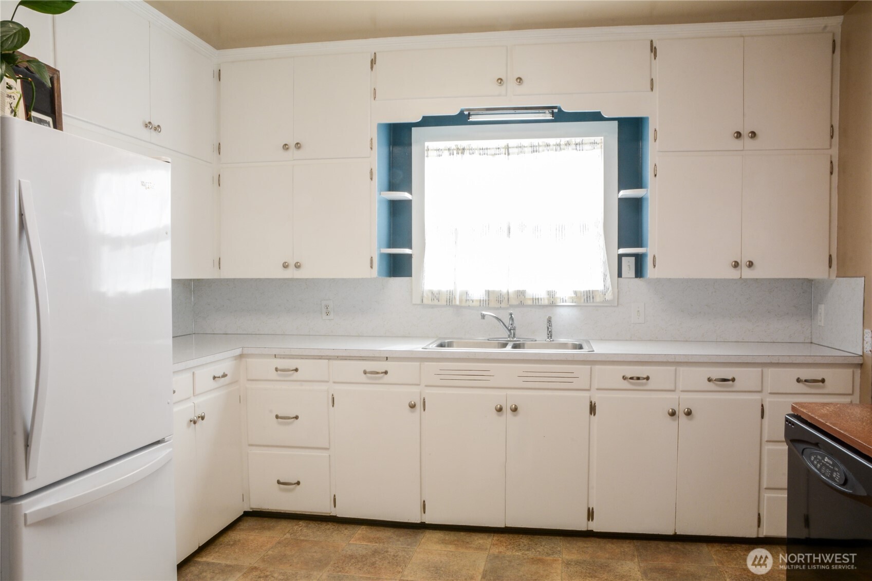 112 East 5th Street Lind, WA 99341 - Photo 9 of 39 a kitchen with appliances cabinets and a sink