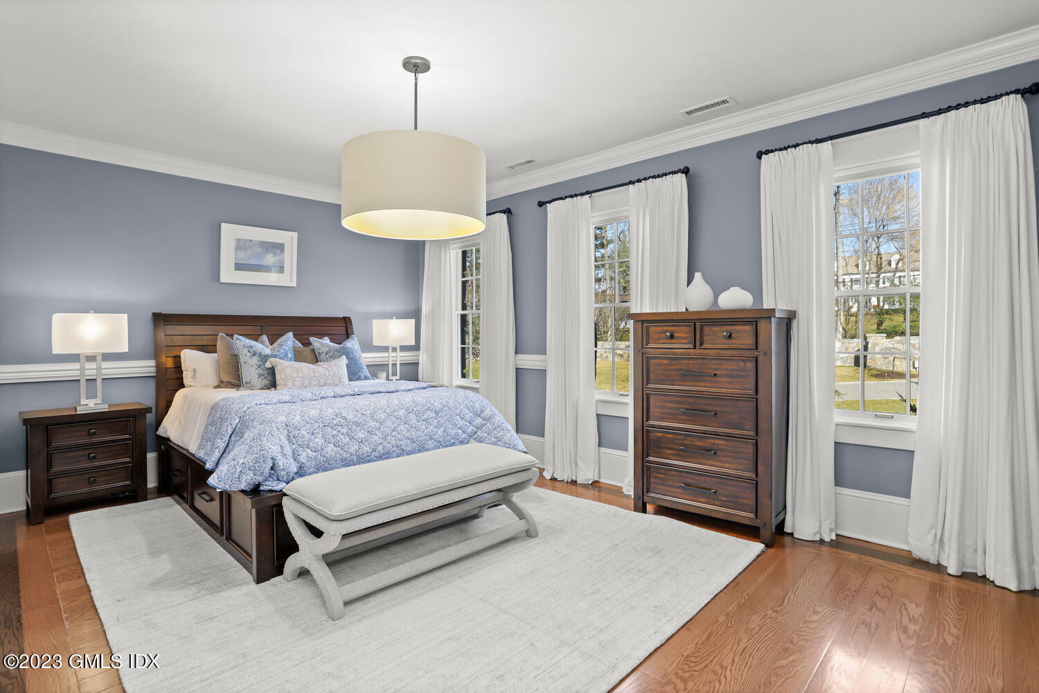 28 Dairy Road Greenwich, CT 06830 - Photo 30 of 44 a bedroom with a bed and a chandelier