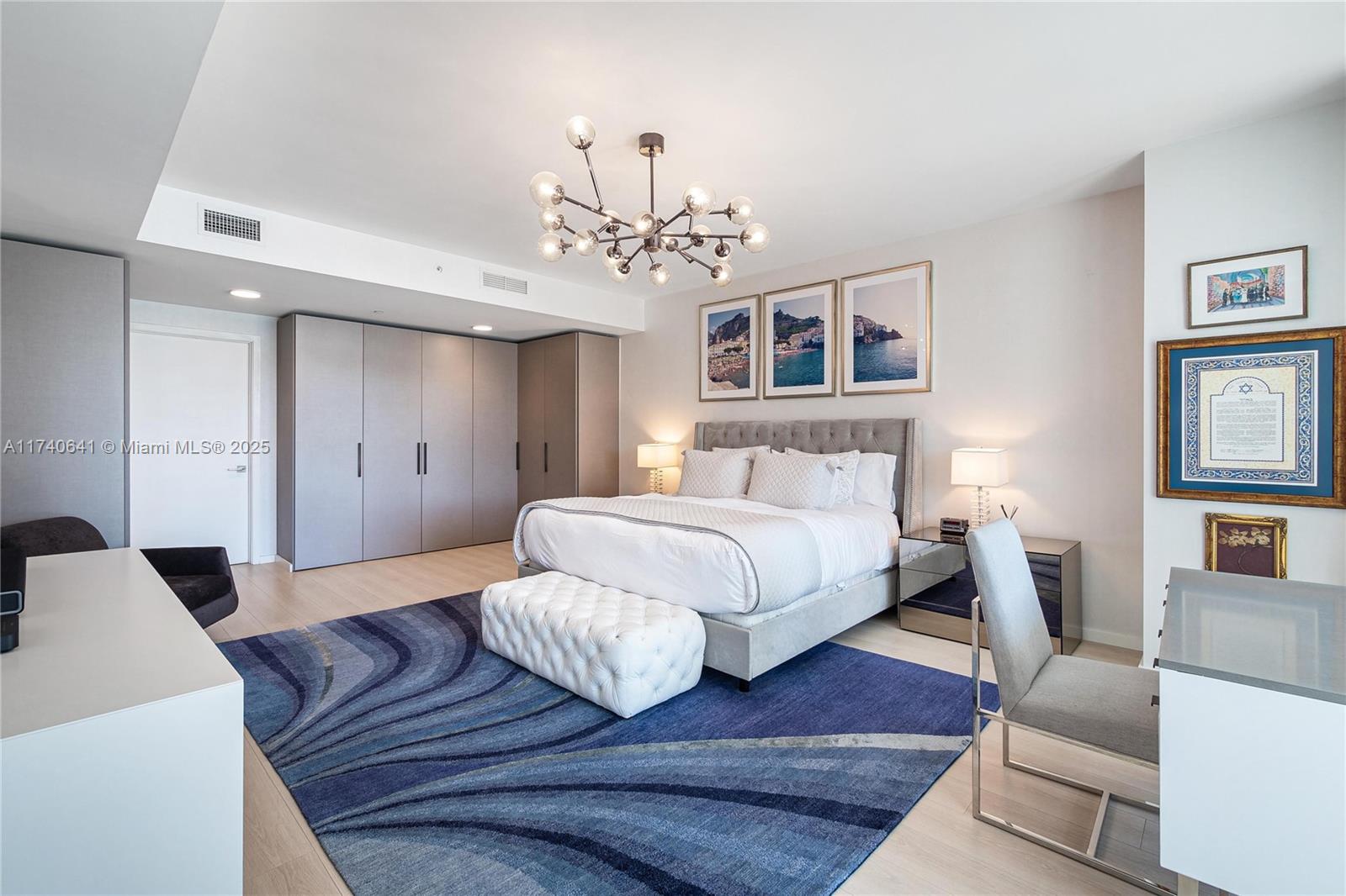 1 Collins Avenue, Unit 304 Miami Beach, FL 33139 - Photo 15 of 40 a bedroom with a bed wooden floor and window