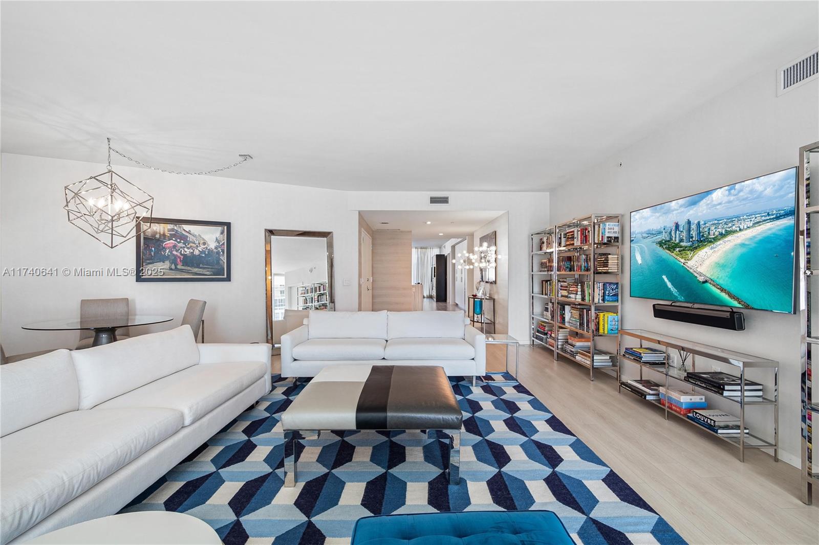 1 Collins Avenue, Unit 304 Miami Beach, FL 33139 - Photo 2 of 40 a bedroom with furniture and a flat screen tv