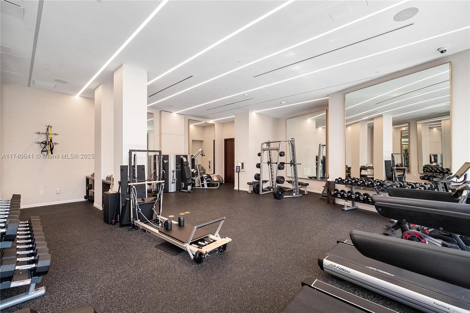 1 Collins Avenue, Unit 304 Miami Beach, FL 33139 - Photo 27 of 40 a room with gym equipment