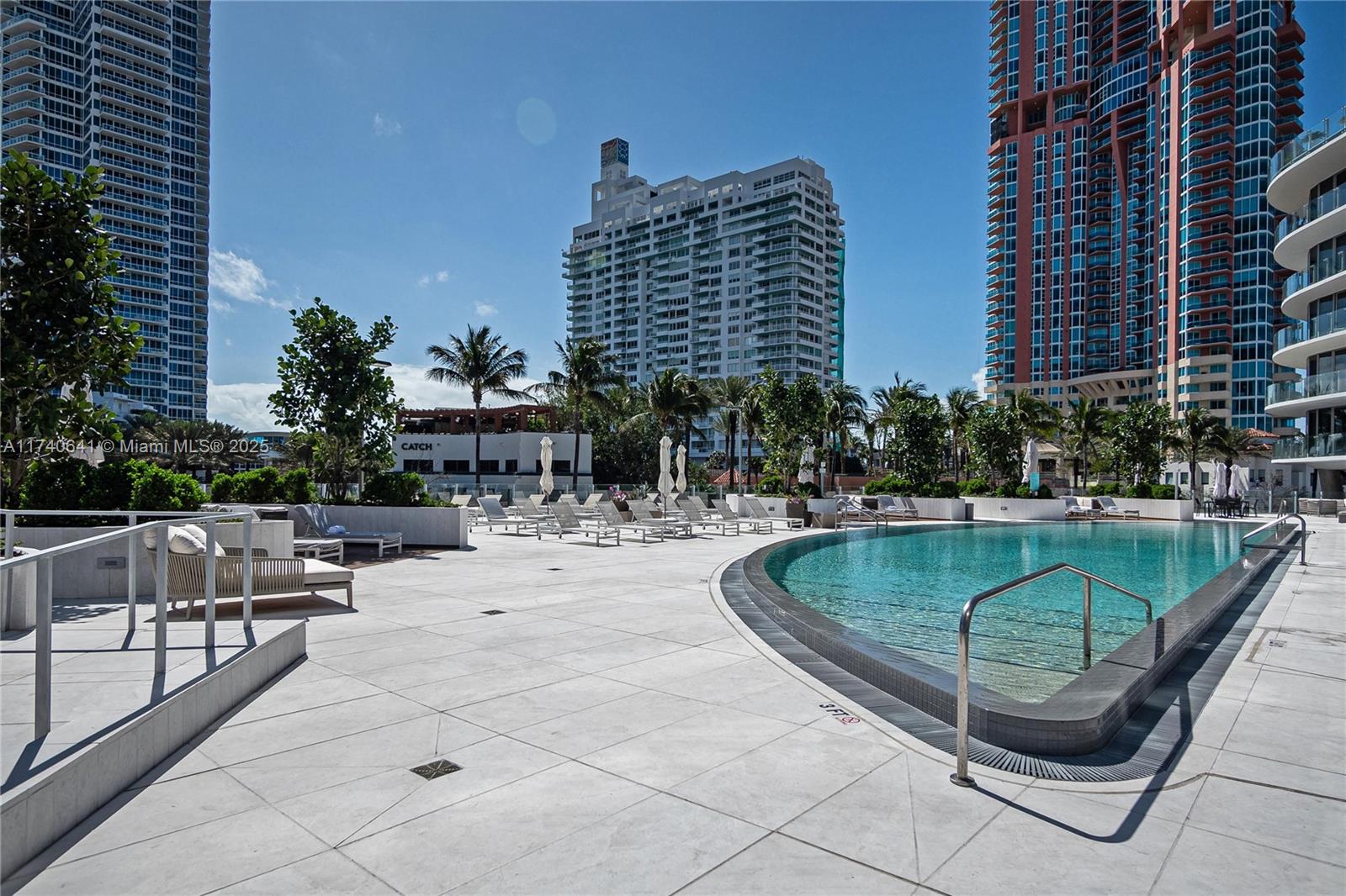 1 Collins Avenue, Unit 304 Miami Beach, FL 33139 - Photo 30 of 40 a swimming pool with outdoor seating and yard