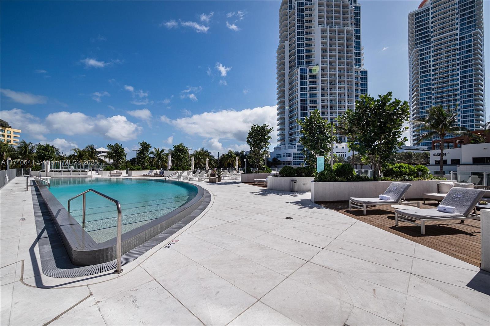 1 Collins Avenue, Unit 304 Miami Beach, FL 33139 - Photo 31 of 40 a view of a swimming pool with sitting area