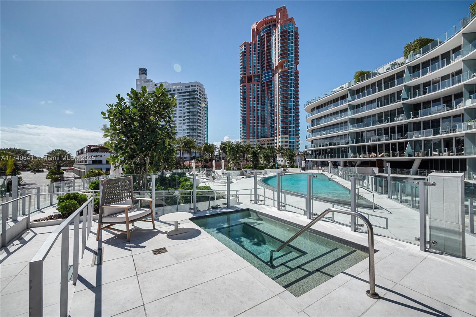 1 Collins Avenue, Unit 304 Miami Beach, FL 33139 - Photo 33 of 40 a view of a patio with a table and chairs