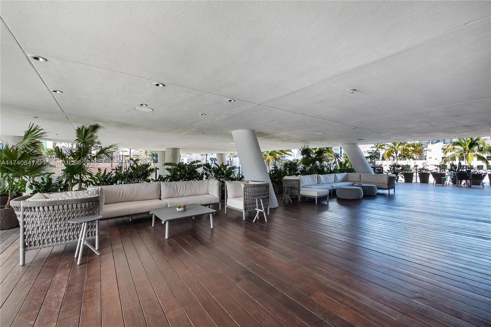 1 Collins Avenue, Unit 304 Miami Beach, FL 33139 - Photo 34 of 40 a living room with furniture and a wooden floor