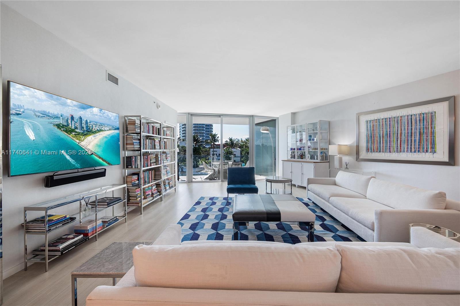 1 Collins Avenue, Unit 304 Miami Beach, FL 33139 - Photo 7 of 40 a living room with furniture and a flat screen tv