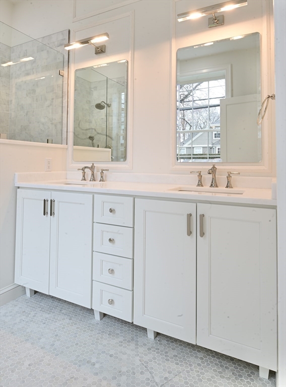 66 Pleasant Street, Unit 1 Marblehead, MA 01945 - Photo 13 of 19 a bathroom with double sink and a mirror