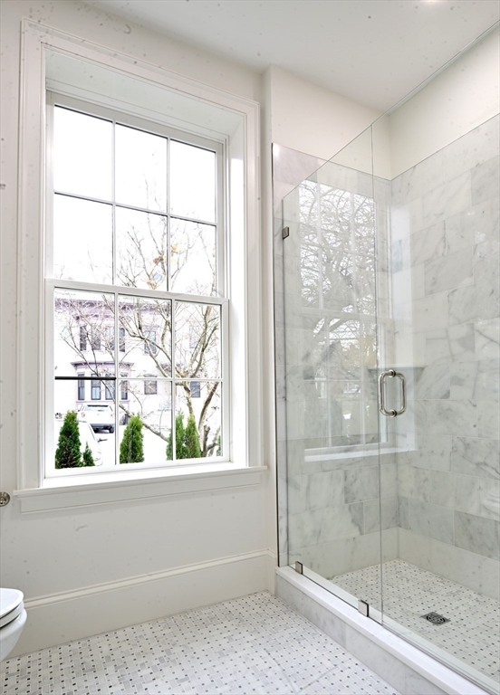 66 Pleasant Street, Unit 1 Marblehead, MA 01945 - Photo 17 of 19 a bathroom with a glass shower door