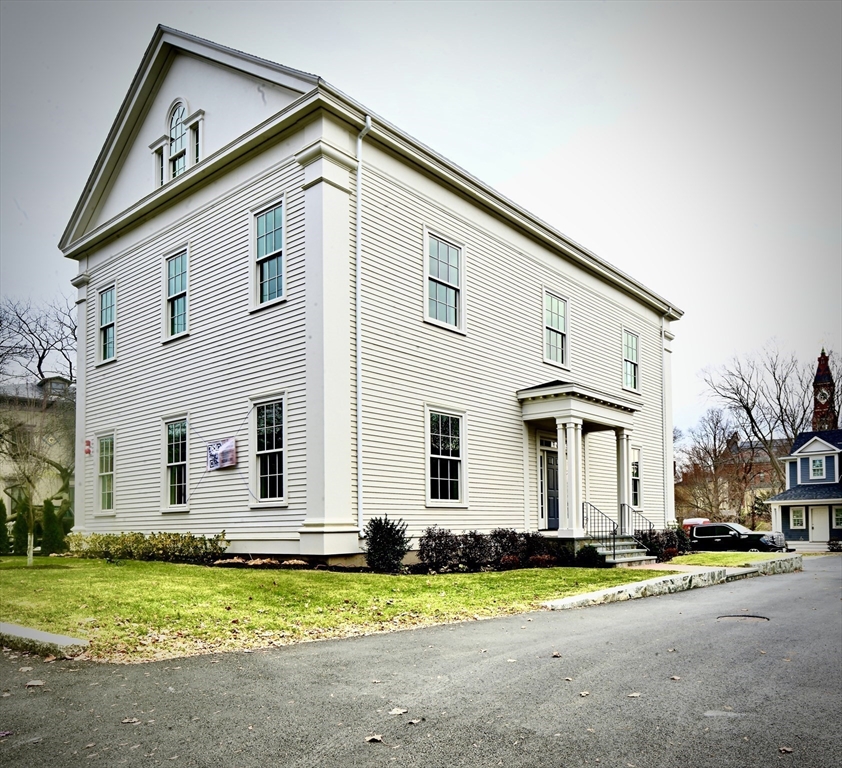 66 Pleasant Street, Unit 1 Marblehead, MA 01945 - Photo 2 of 19 a front view of a house with a yard