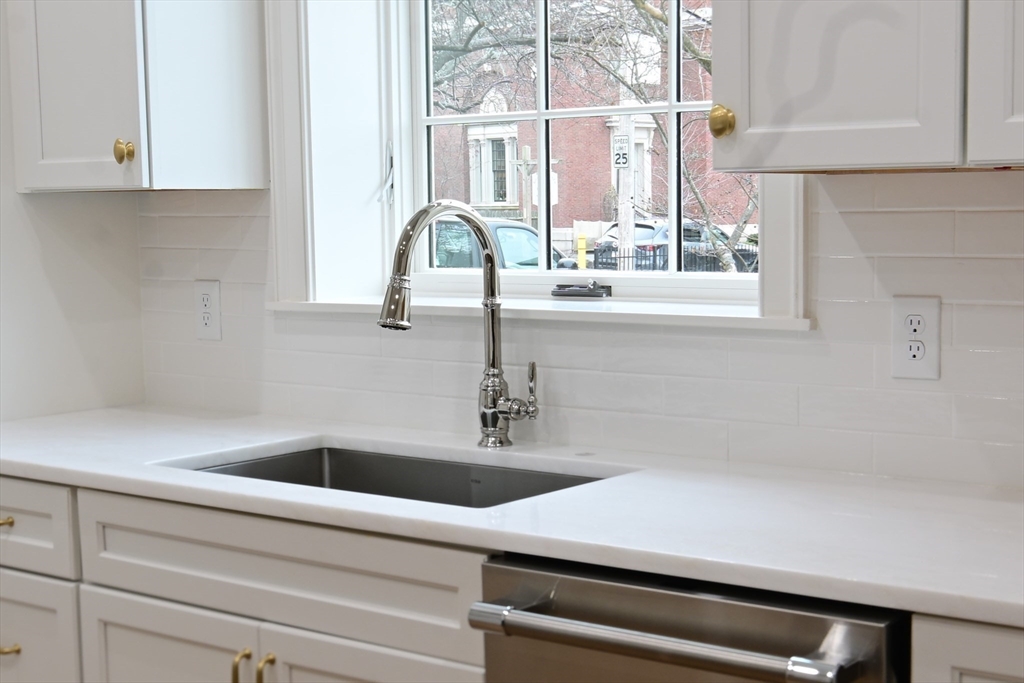 66 Pleasant Street, Unit 1 Marblehead, MA 01945 - Photo 8 of 19 a kitchen with a sink and cabinets