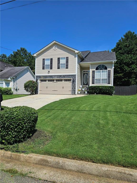 a view of house with yard and green space