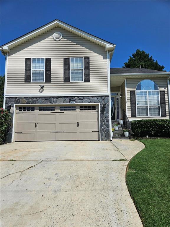 4209 Reeshemah Street Atlanta, GA 30349 - Photo 2 of 12 a front view of a house with a yard