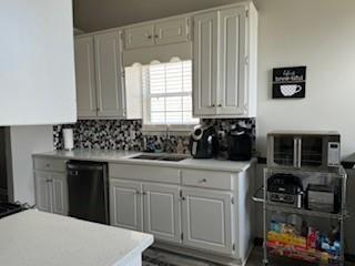 4209 Reeshemah Street Atlanta, GA 30349 - Photo 4 of 12 a kitchen with white cabinets and black appliances