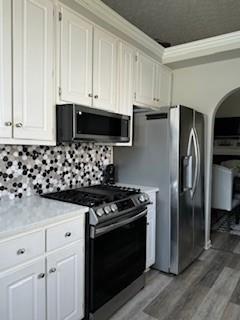4209 Reeshemah Street Atlanta, GA 30349 - Photo 5 of 12 a kitchen with stainless steel appliances a stove a microwave and a refrigerator