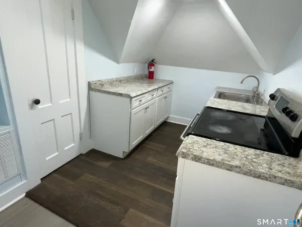 a utility room with wooden floor washer and dryer