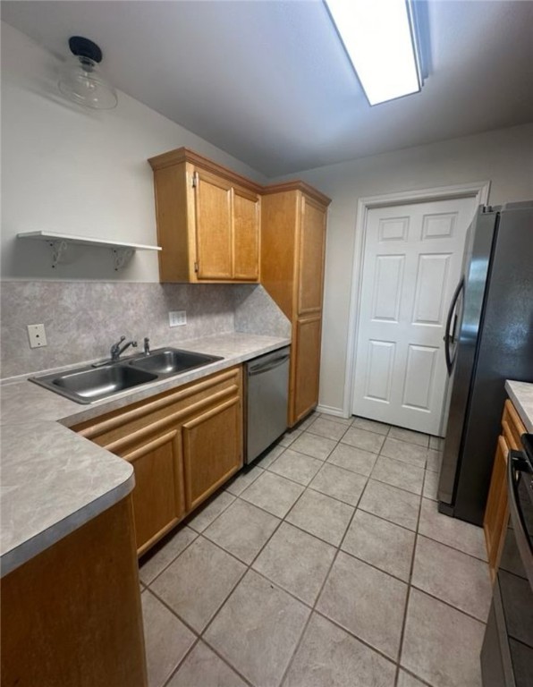 15618 Cruiser Street Corpus Christi, TX 78418 - Photo 11 of 14 a kitchen with a sink a stove and refrigerator