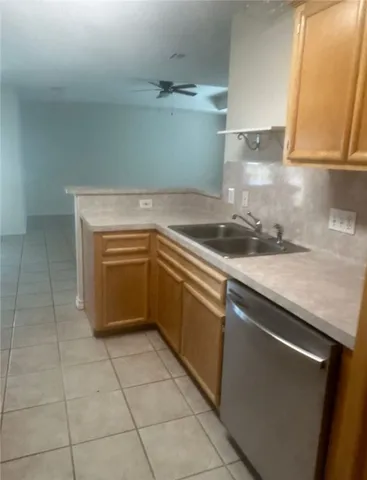 a kitchen with granite countertop a stove and a sink