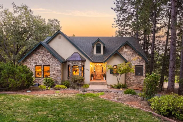 a front view of house with yard and green space