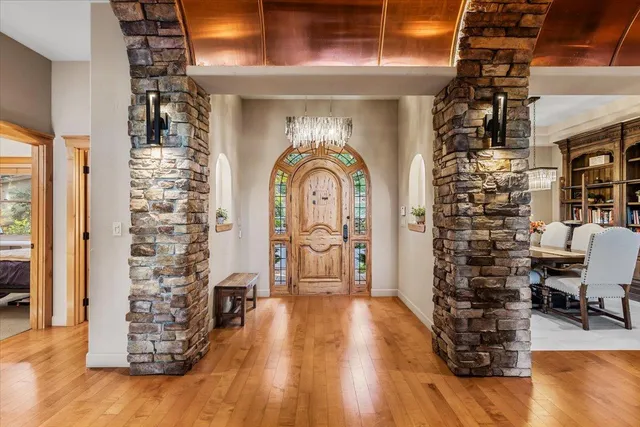 a living room with fireplace furniture and wooden floor