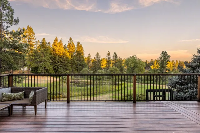 a view of a terrace with trees in the background