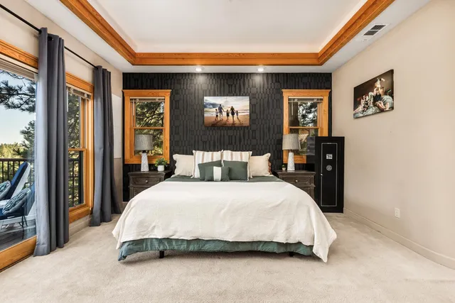 a spacious bedroom with a bed and a large mirror