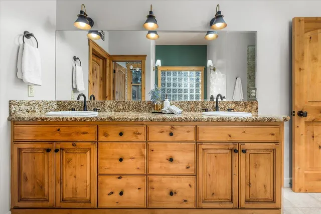 a bathroom with a sink vanity and mirror