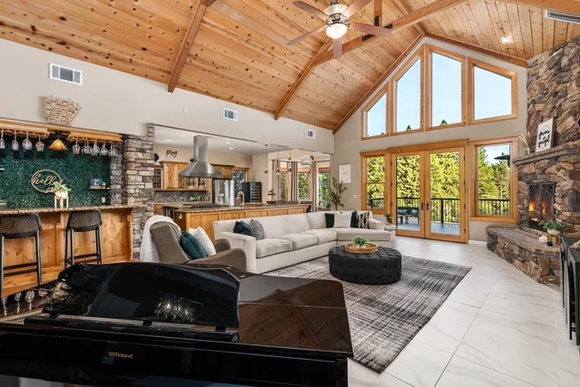 a living room with furniture and a floor to ceiling window