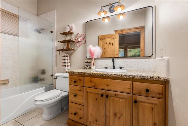 a bathroom with a toilet a sink and mirror