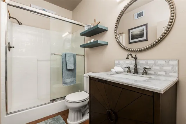 a bathroom with a toilet a sink and mirror