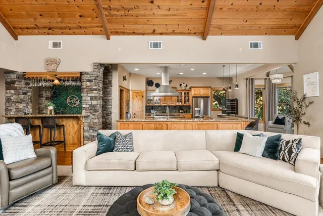 a view of a living room a rug and a floor to ceiling window