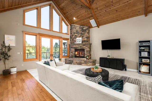 a living room with furniture a fireplace and a flat screen tv
