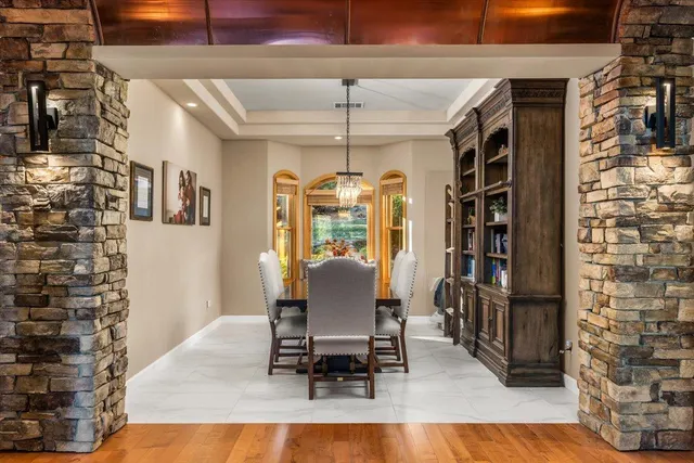 a dining room with furniture a rug and wooden floor