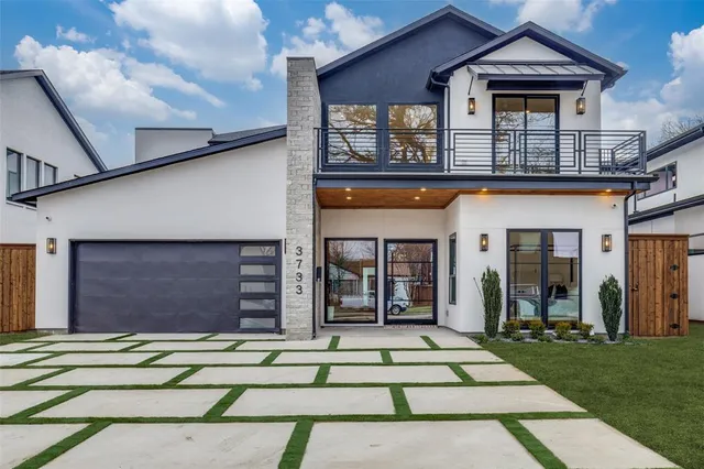 a front view of a house with a garden and plants