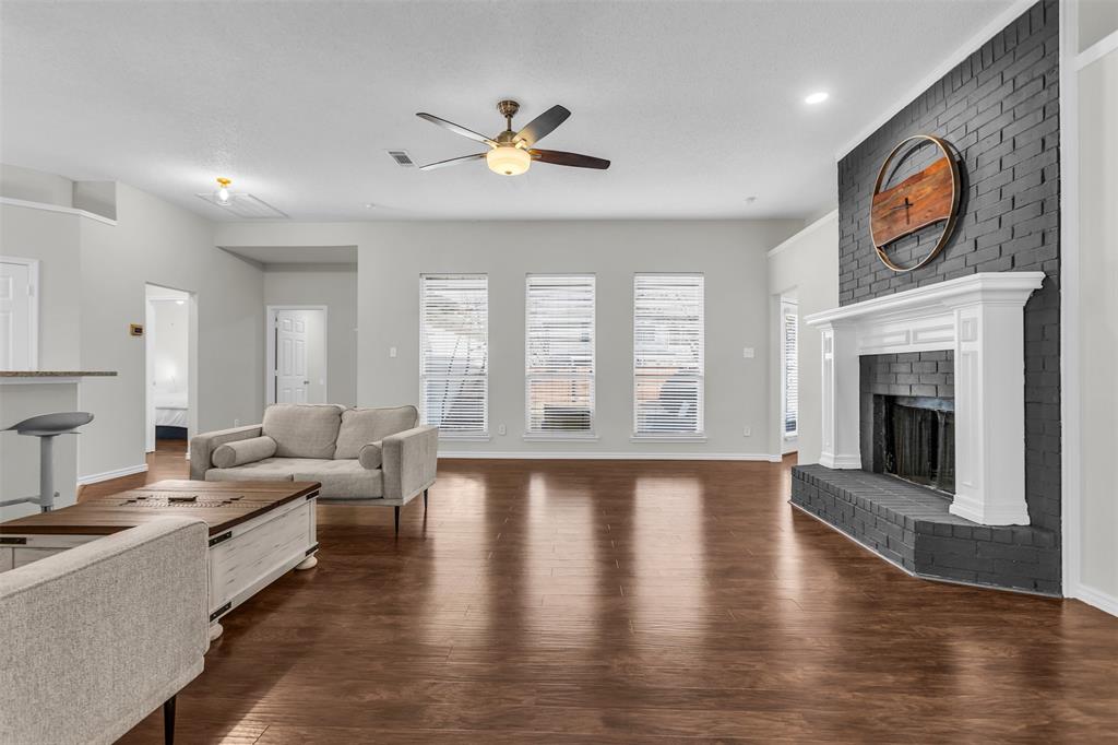 308 Glen Ridge Drive Murphy, TX 75094 - Photo 23 of 36 a living room with furniture and a fireplace