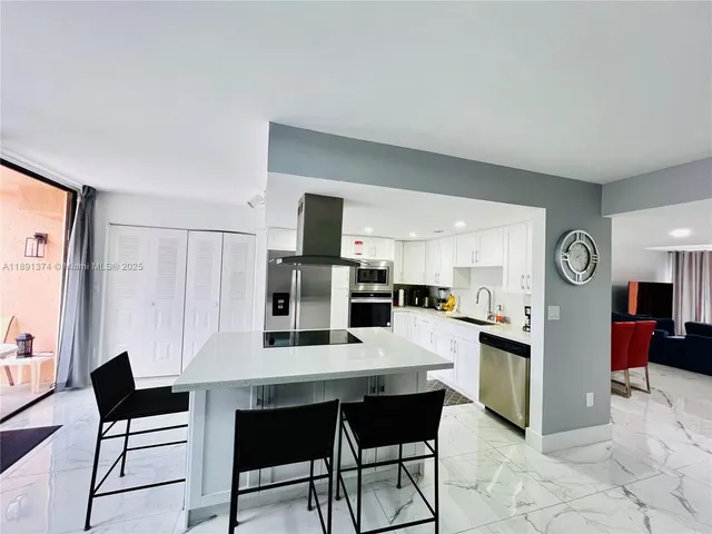 a living room with furniture and large windows